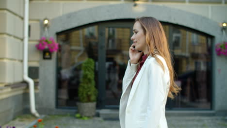 Smiling-businesswoman-calling-phone-outdoors.-Serious-business-woman