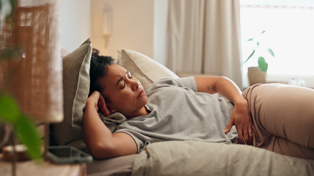 Woman Sleeping in Bed with Apparent Pain