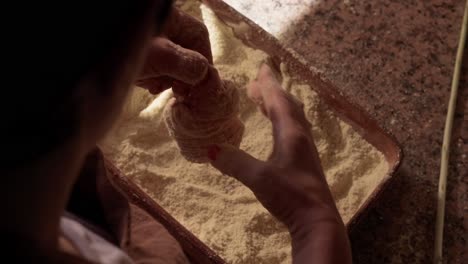minho woman coats pork intestines with cornmeal in north portugal sausage ritual
