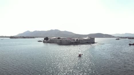 4k aerial drone footage of the beautiful taj lake palace on the lake pichola near the city of udaipur, india
