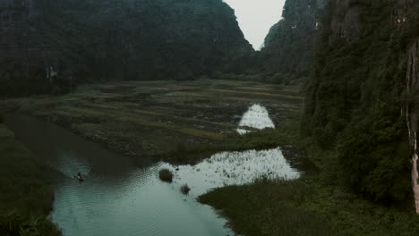 drone flying over water above lookout point in nihn bihn vietnam