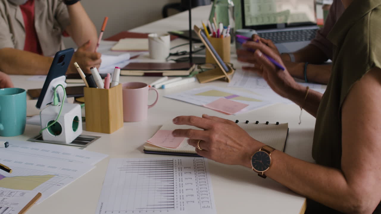 People Collaborating and Analyzing Data at a Business Meeting