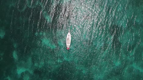 tour boat on a blue sea paradise, darkwood beach, antigua - aerial top down