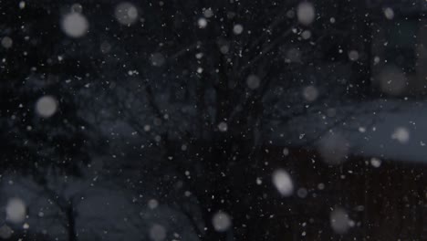 january snowfall in the evening with the camera panning down to focus on a snow-covered wooden fence
