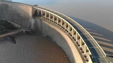 drone flight over dam wall with high water levels