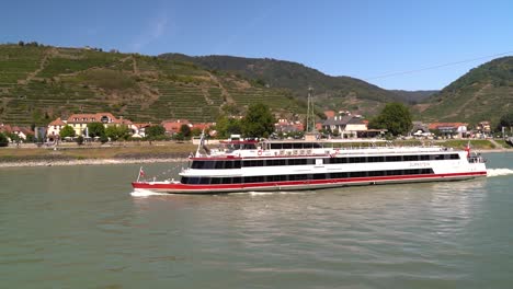 slow motion view of tourist cruise ship on danube river in wachau, austria