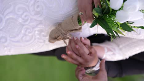 the groom and the bride are holding hand and ready for their photo session vertical video