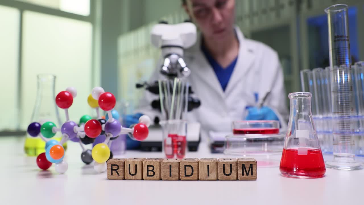 Scientist conducts chemistry experiment with Rubidium in a laboratory