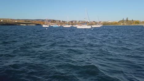 Sailboats-on-a-lake-houses-in-distance-Ghost-lake-Alberta-Canada