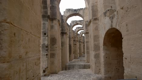 arch corridor of ancient roman ruins in el jem amphitheater in tunisia