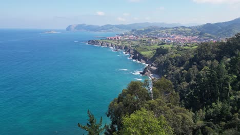 green coast and beach in bermeo, bay of biscay, basque country, north spain - aerial 4k