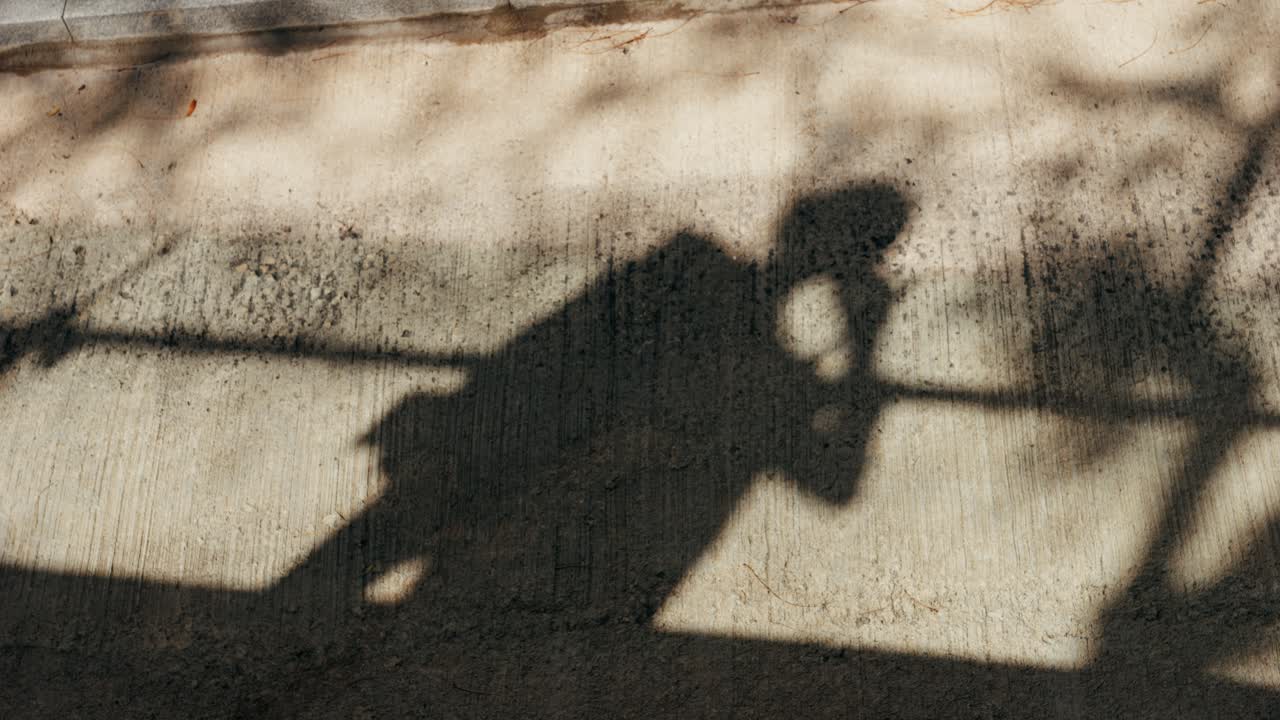 Shadow of a person on the sidewalk