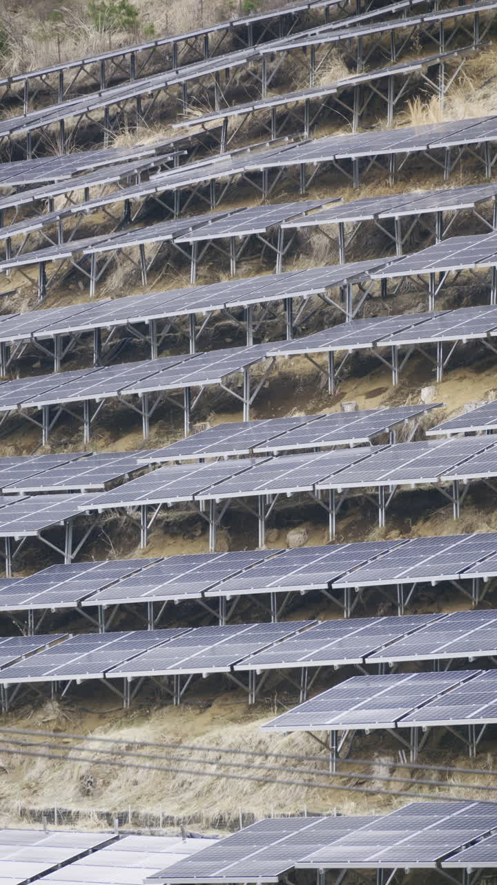 Renewable energy generation takes form as solar panels are installed on terraces in a rural location, showcasing eco-friendly technology in agriculture. Vertical video. Japan