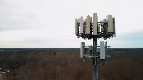 aerial shot revolving around cell phone tower in forest. 4k drone