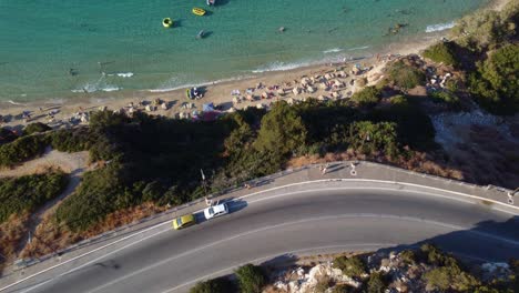 aerial view of coastal road and beach with clear blue water