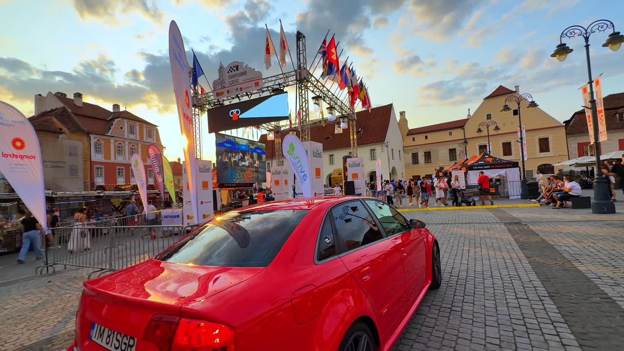Sibiu, Romania, 17 July 2025: Red Audi car in Sibiu square. Bright red Audi car parked in the historic square of Sibiu, Romania