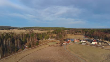 drone shot of farm in sweden at winter but without snow