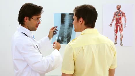 Doctor-looking-at-xray-with-patient-and-smiling