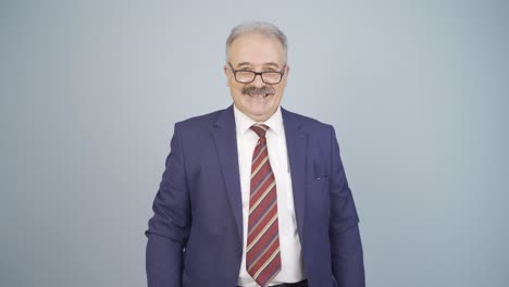 businessman laughing at camera.