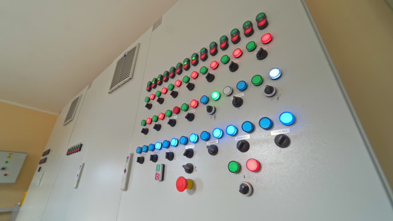 Automated panel with glowing buttons. Control buttons inside the modern industrial plant. Industrial equipment indoors.