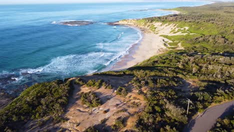 drone aerial landscape shot track into ocean in soldiers beach cove norah head central coast nsw australia 4k