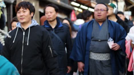 traditional geishas navigate a busy urban setting.