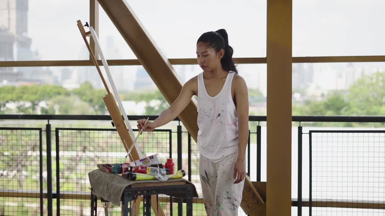 Artist Woman Painting on Canvas with Easel in a Modern Elevated Setting
