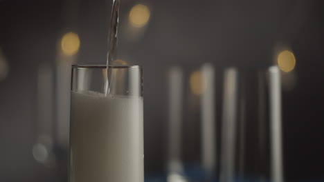 Studio-product-shot-of-pouring-champagne-into-glass-with-nice-blurred-background