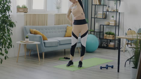 senior woman doing stretching exercises at home