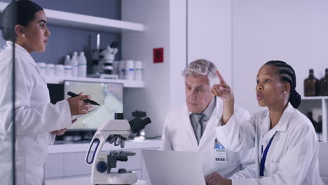 team of scientists working on laptop in a medical