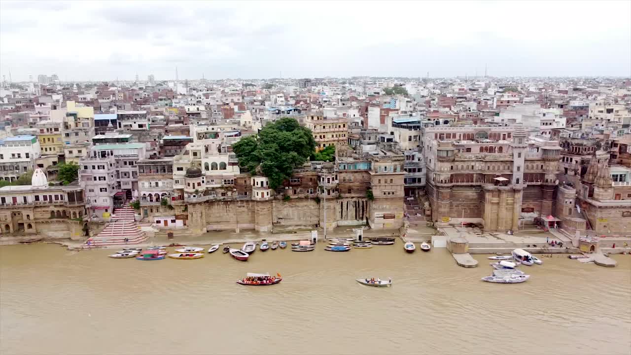 Breathtaking aerial footage of Varanasi from the Ganges River, showcasing the city's historic ghats, vibrant temples, and sacred waters