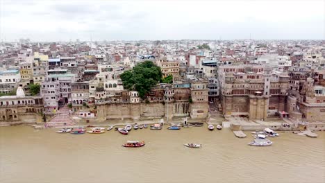 breathtaking aerial footage of varanasi from the ganges river, showcasing the city's historic ghats, vibrant temples, and sacred waters