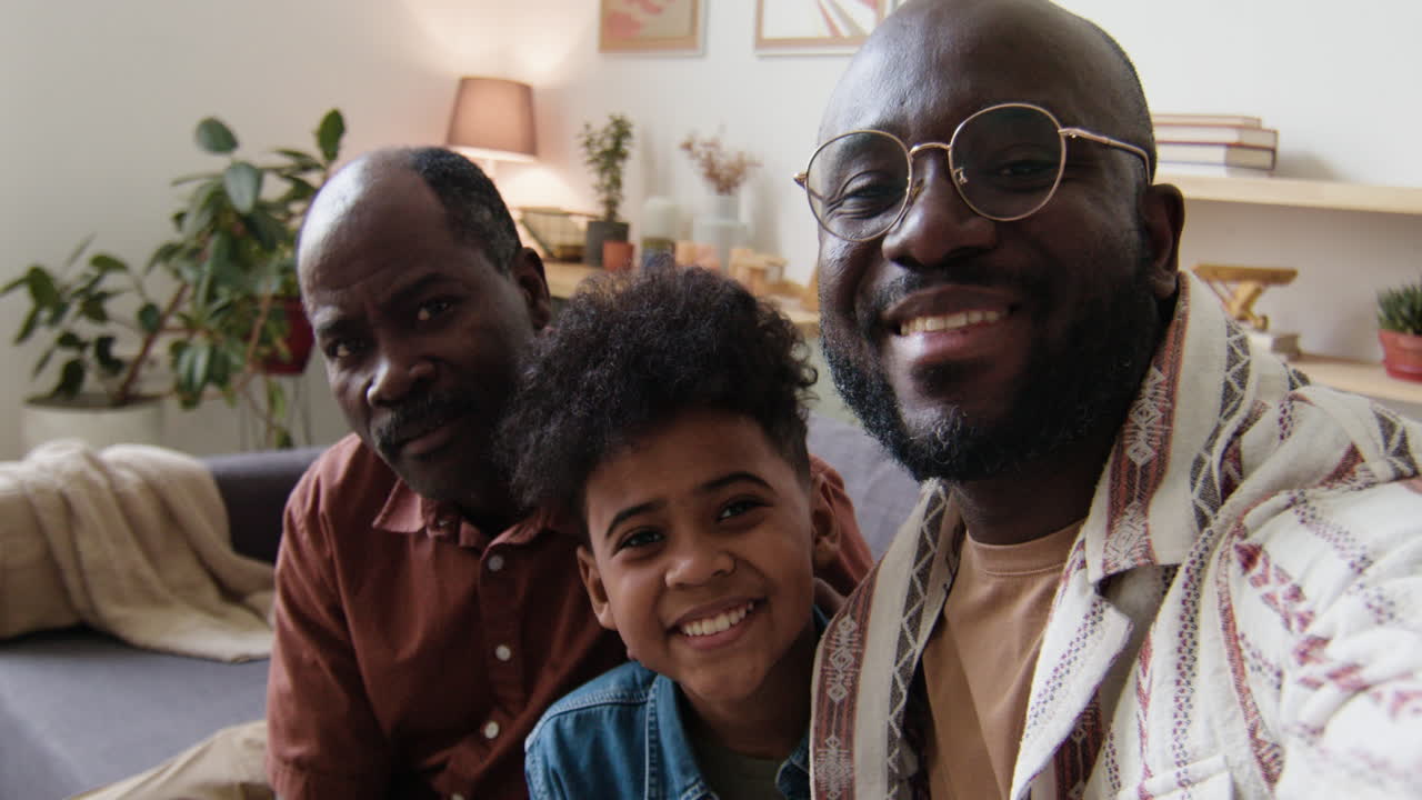 Selfie of black men and boy in the living room