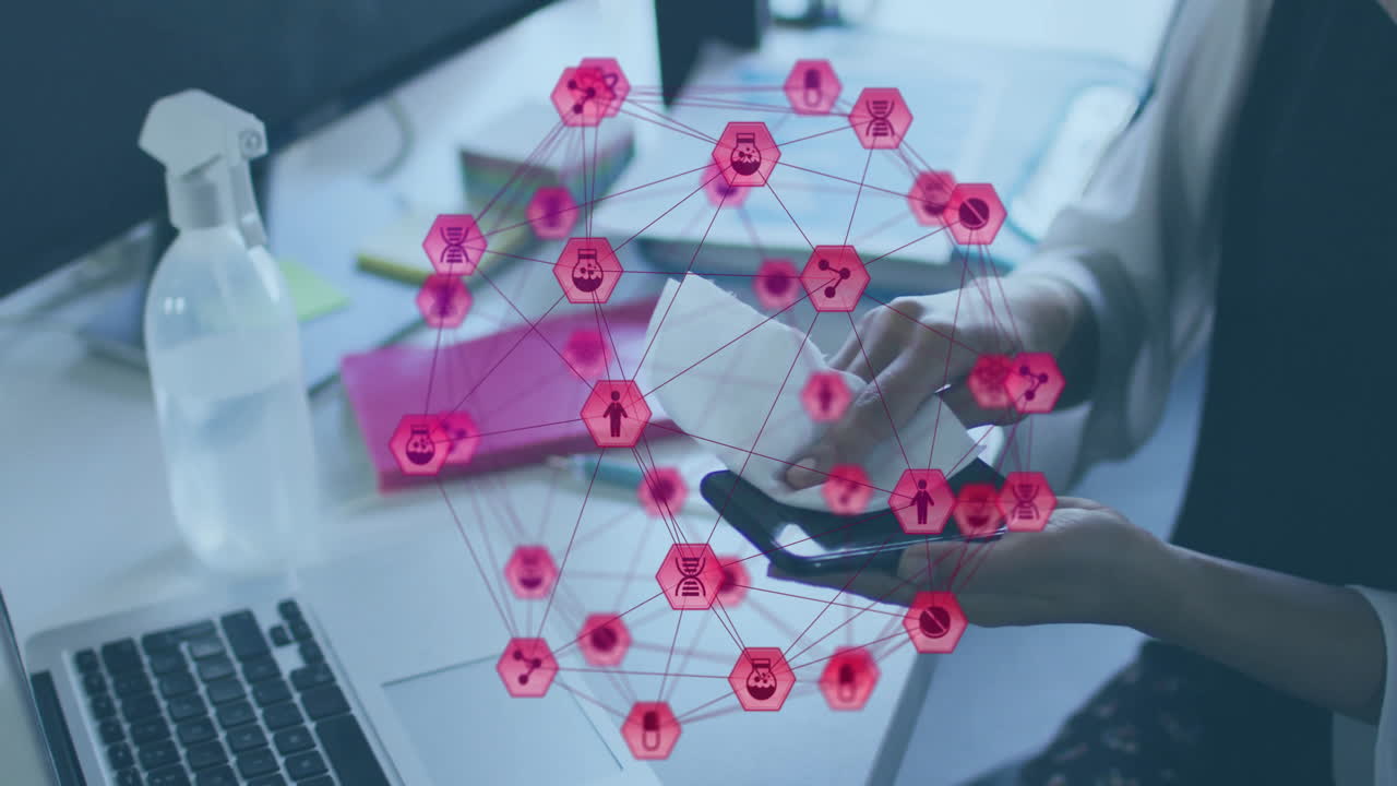 Network of interconnected icons animation over person using smartphone at desk