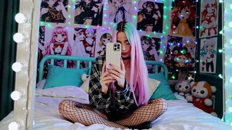 young woman taking a selfie in a cozy anime-themed bedroom