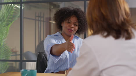 Relieved-Woman-Being-Given-All-Clear-Shaking-Hands-With-Doctor-Or-Oncologist-At-Meeting-In-Treatment-Clinic-For-Breast-Cancer-In-Hospital