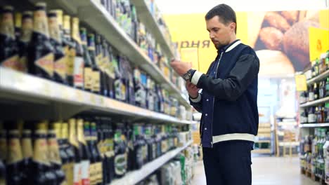 hombre comprando cerveza en una tienda de comestibles