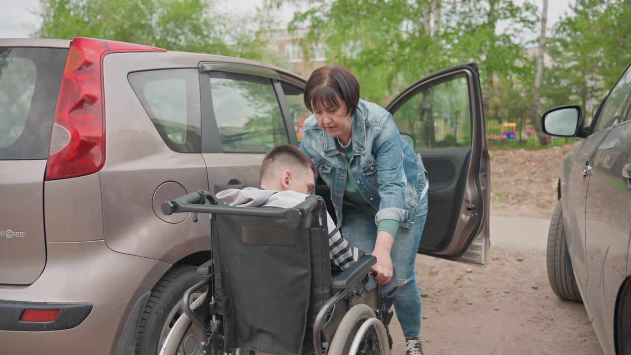 Assistive Parking Preparation, Caregiver Carefully Aligns Wheelchair For Passenger Safety And Comfort, Assistant Adjusts Wheelchair At Vehicle Door To Facilitate Safe And Smooth Passenger Transfer