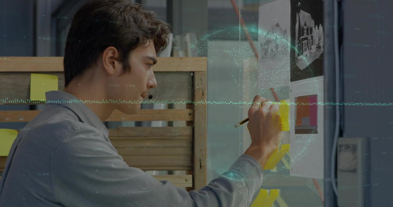 Mand rækker op og organiserer gule sticky notes på glas, der kortlægger designidéer med holografisk synkronisering