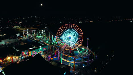 Nighttime-orbital-drone-shot-of-santa-monica-pier-and-ferris-wheel