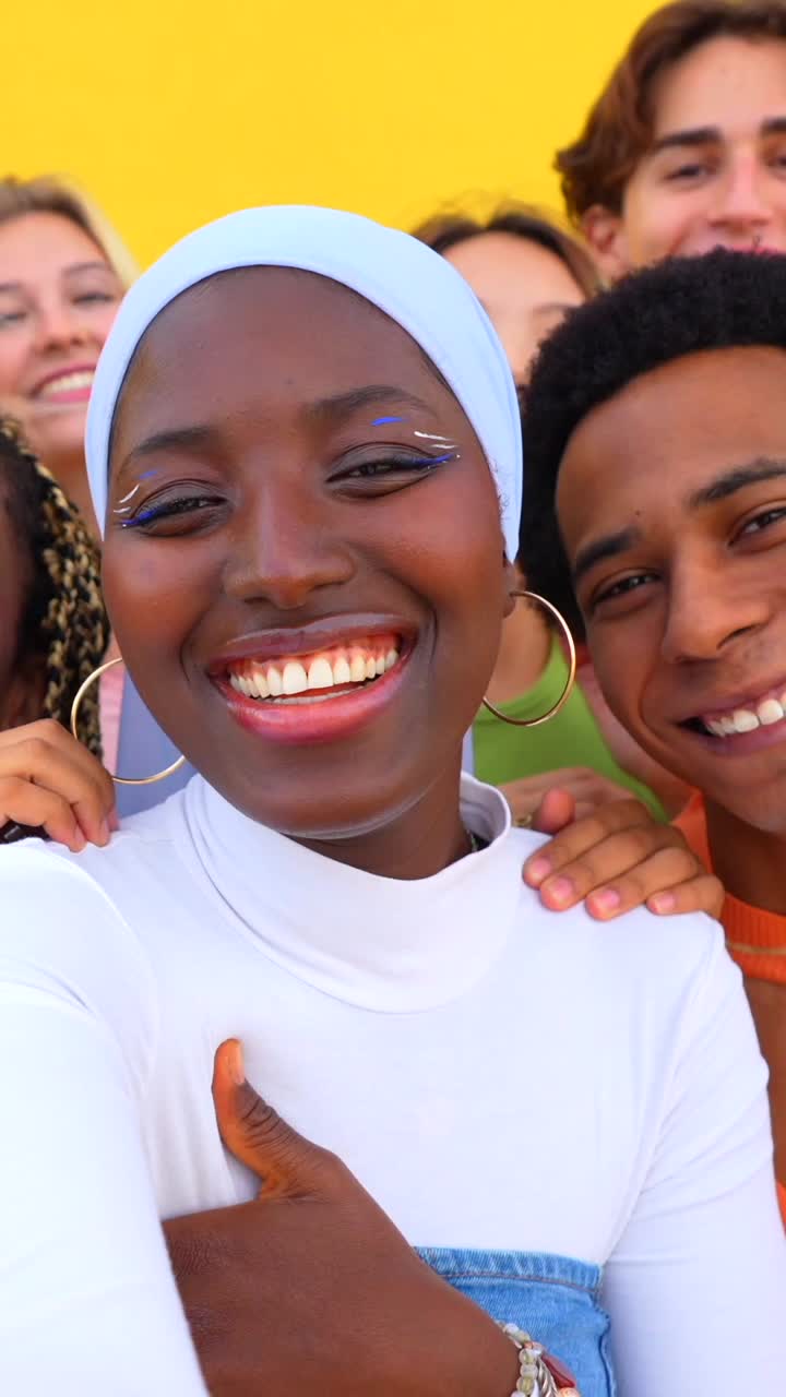 Group of diverse friends smiling and giving thumbs up
