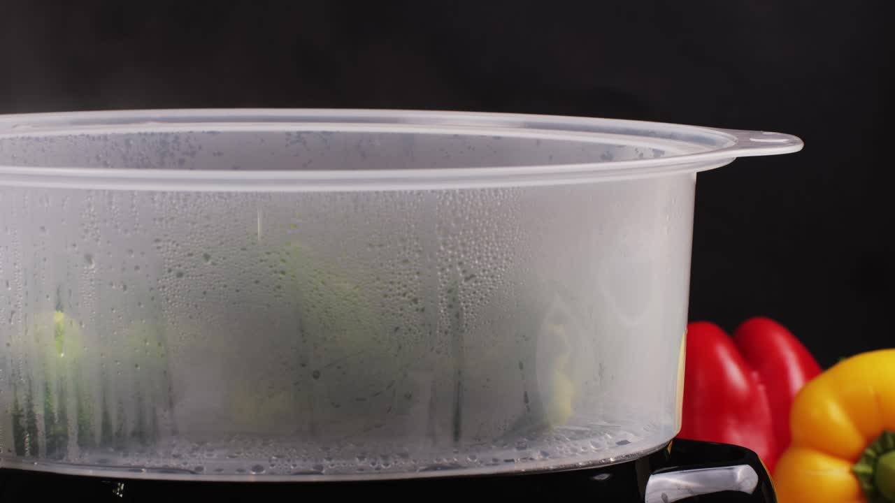 Mixed vegetables, carrots, broccoli, and cauliflower in a food double boiler steamer basket in a stainless steel pot, healthy diet cooking method preserving minerals, vitamins and flavor
