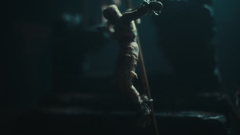 a miniature scene of the mummified dolls hanging on the gallows at night
