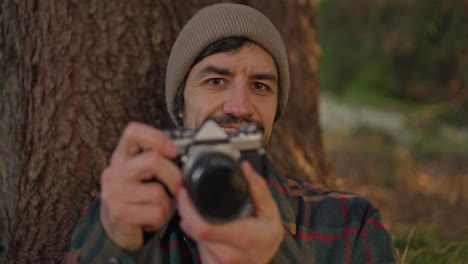 man taking a photo with a vintage camera