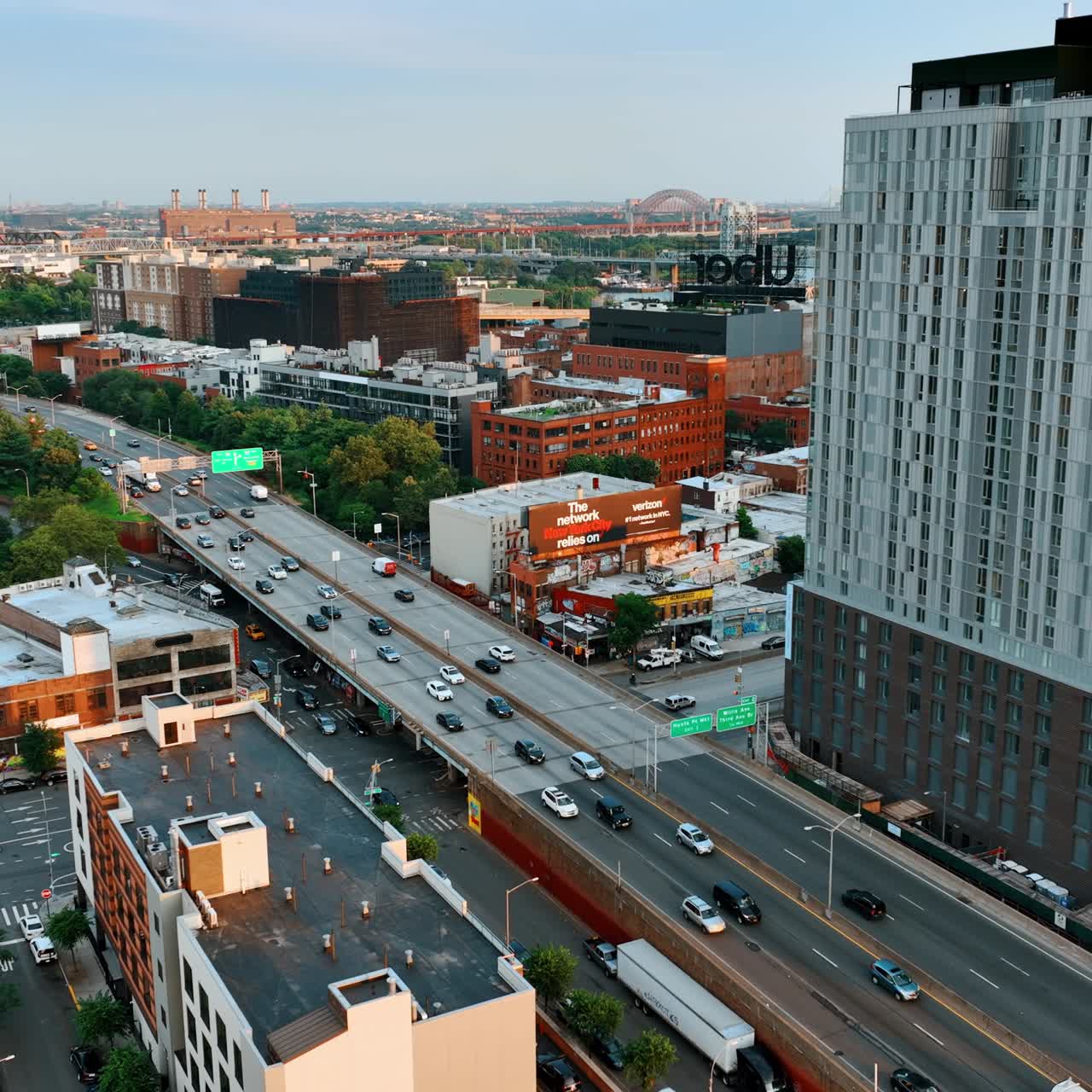 Cars move quickly by the roads and freeways of New York. Cityscape of amazing New York from aerial view