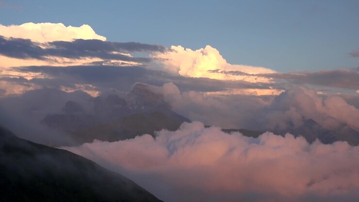 Majestic Mountain Peaks Rising Above a Sea of Clouds at Sunset