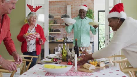 happy group of diverse senior friends celebrating meal at christmas time