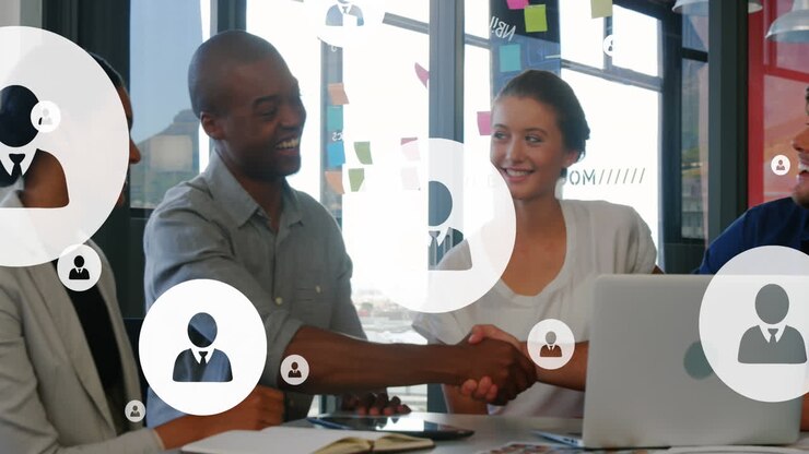 Animation of profile icons over diverse coworkers shaking hands after discussing in office