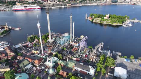 aerial reveal from grona lund amusement park to beautiful stockholm cityscape, sweden