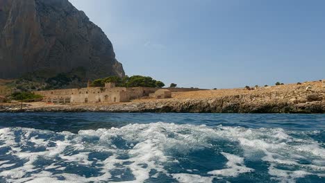 old sicilian seafront tonnara del secco used for tuna fishing as seen from boat in sicily